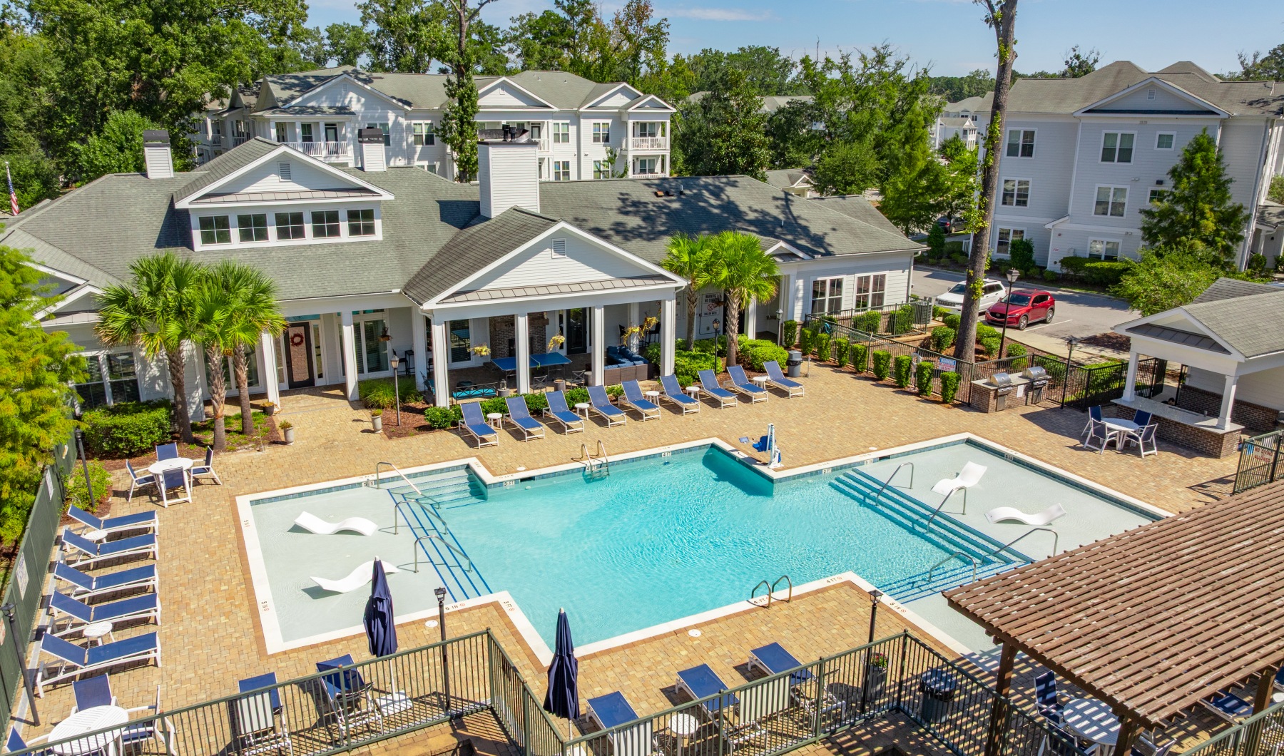 pool area showing reclining seating, wooden coverings and ample space